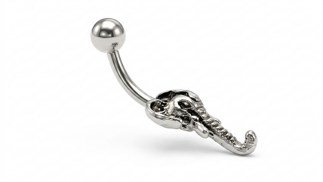 Close-up of Ganesha belly ring showing detailed sculpting and polished finish